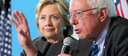 US-Democratic-presidential-nominee-Hillary-Clinton-listens-as-US-Senator-Bernie-Sanders-answers
