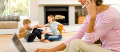 Woman talking on phone and using laptop computer